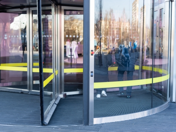 Revolving glass door on modern corporate building